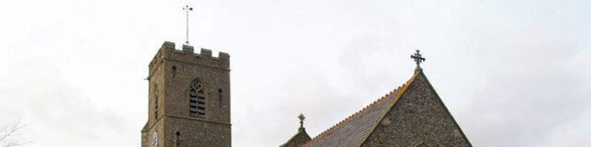 St Martin's parish church, Hindringham, Norfolk, seen from the southeast, with the parish war memorial on the right