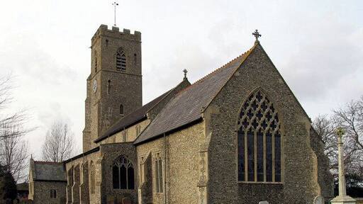 St Martin's parish church, Hindringham, Norfolk, seen from the southeast, with the parish war memorial on the right