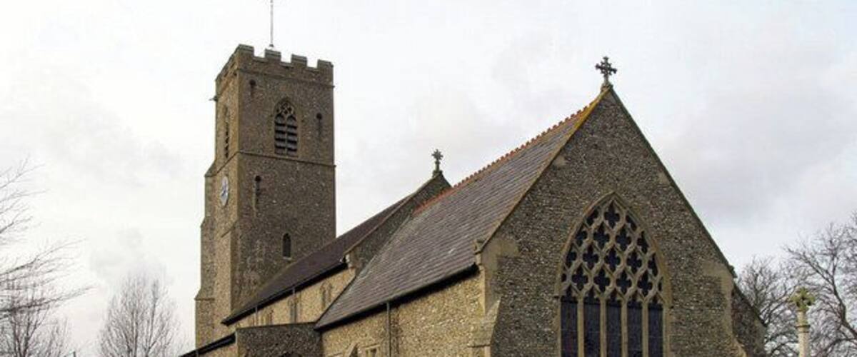 A historic church with a tall tower and arched windows.