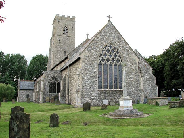 St Martin's parish church, Hindringham, Norfolk, seen from the east, with the parish war memorial between the viewer and the chancel