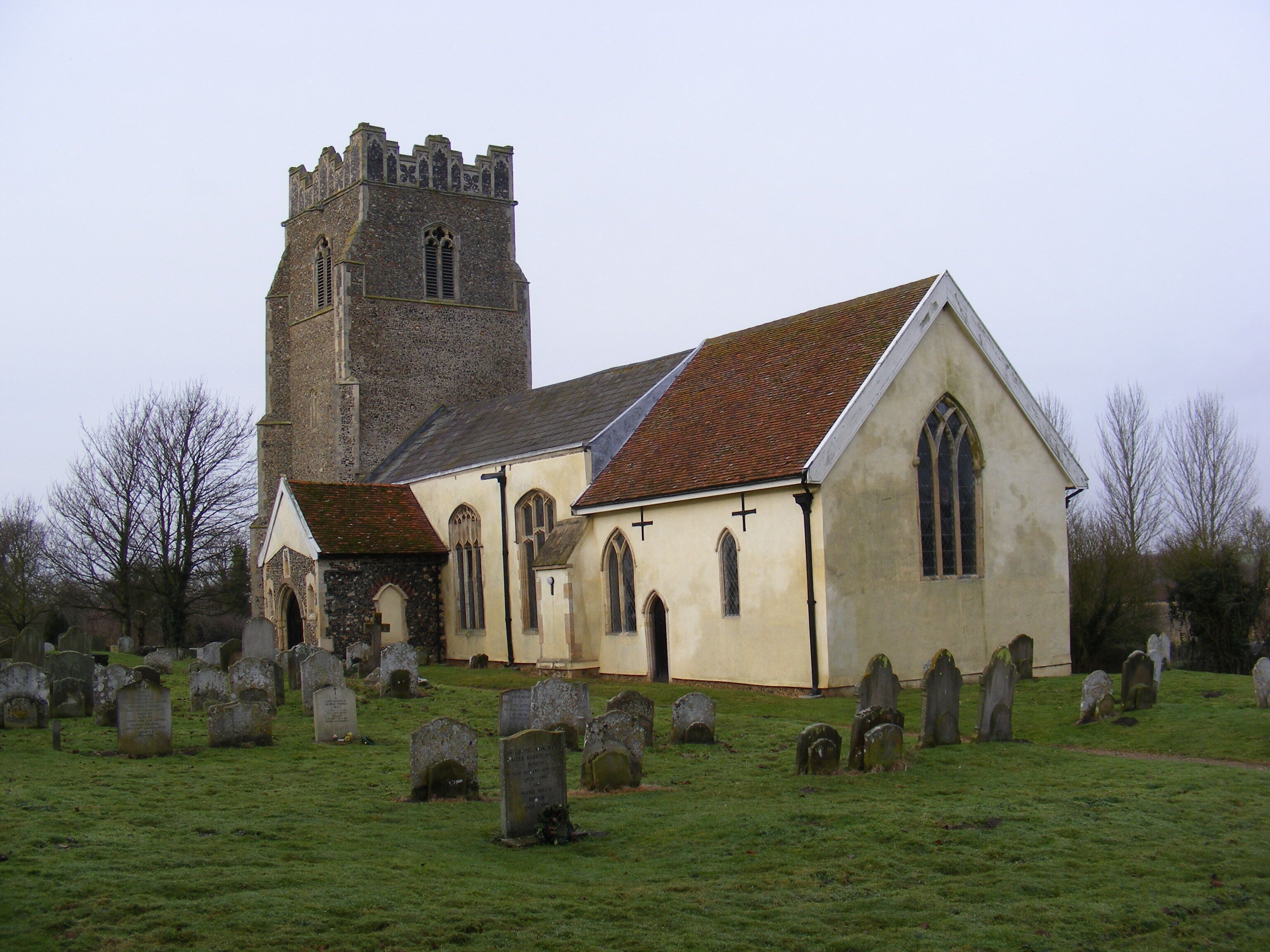 A church with a tower and a graveyard.