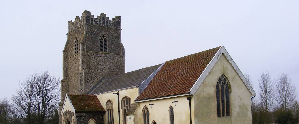A church with a tower and a graveyard.