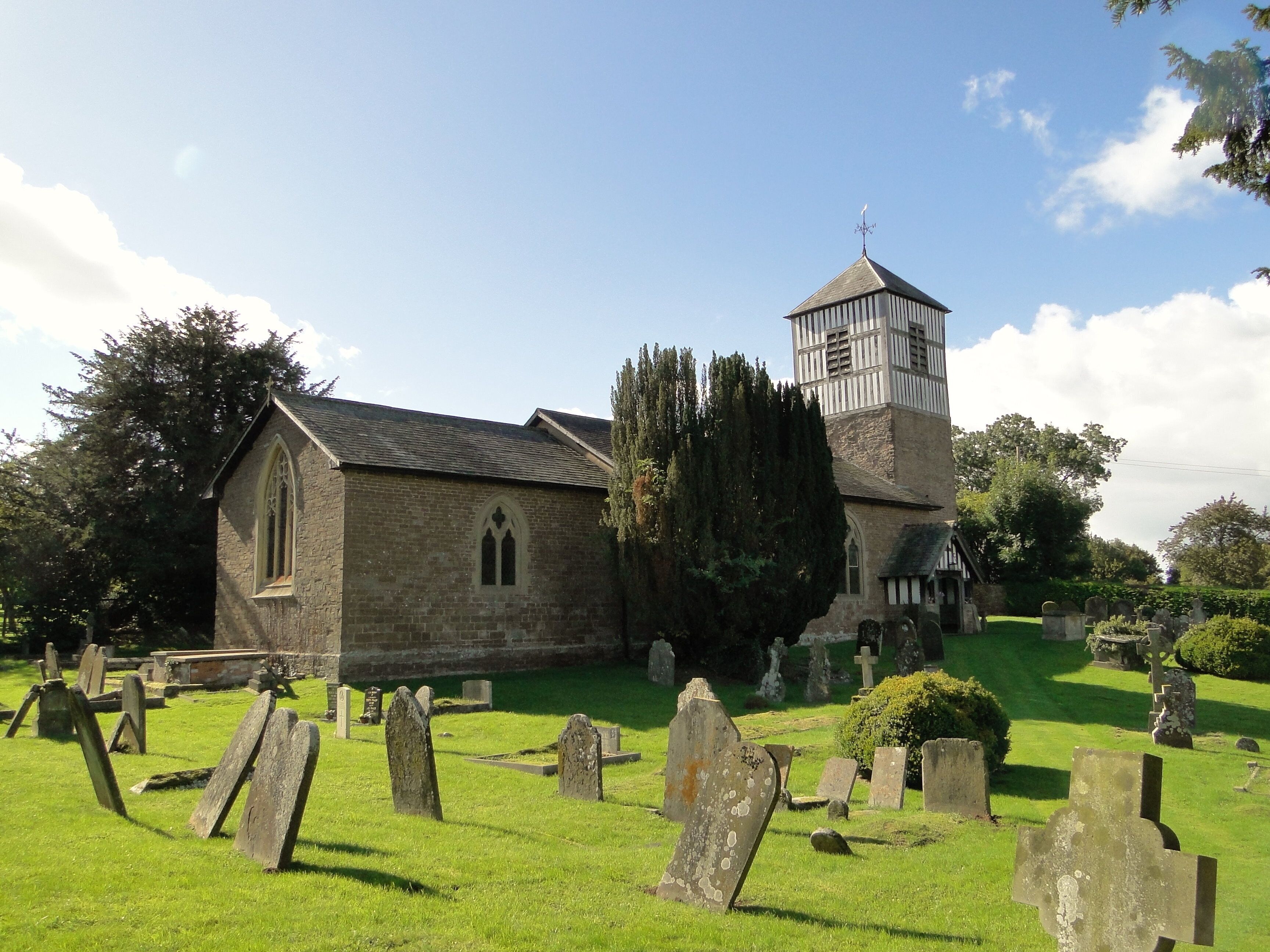 A church with a tower and a graveyard.