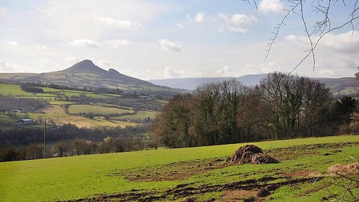 Farmland in Herefordshire The land in the foreground is in England whilst the rest is in Wales. The distinctive hill is Ysgyryd Fawr.