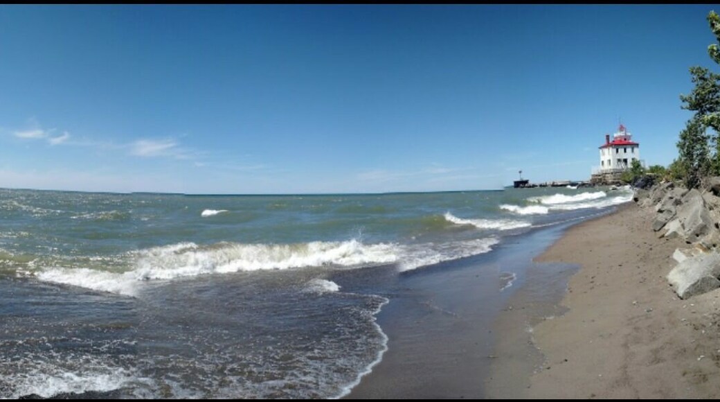 A panoramic view of the beach and light house. At over a mile in length, this is Ohio's largest beach.