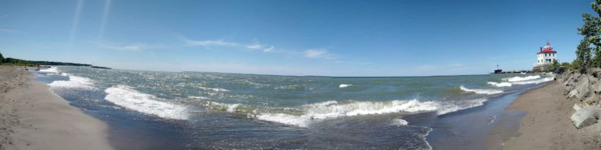 A panoramic view of the beach and light house. At over a mile in length, this is Ohio's largest beach.