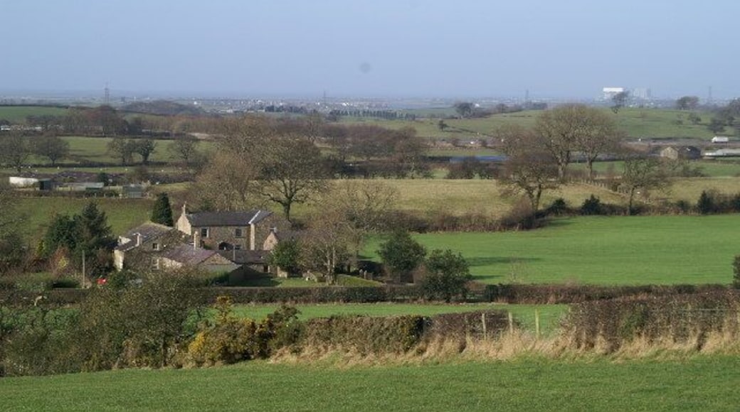 On a clear day. The white roof on the building in the distance, right, is Heysham Nuclear Power Station. The white lorry, extreme right, centre, is on the M6.