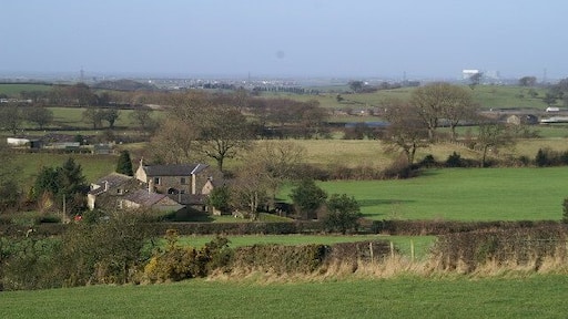 On a clear day. The white roof on the building in the distance, right, is Heysham Nuclear Power Station. The white lorry, extreme right, centre, is on the M6.