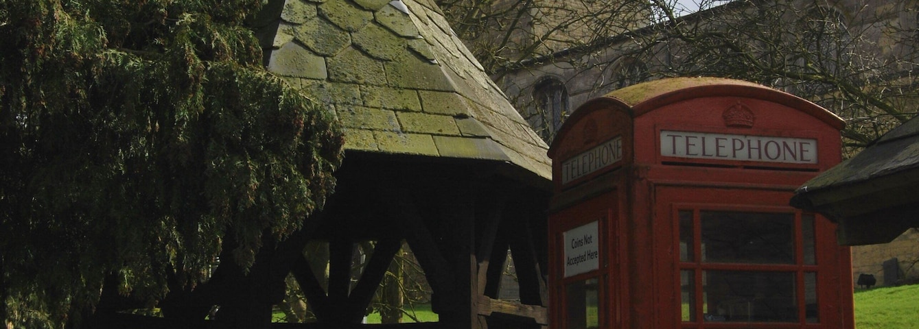 Waltham on the Wolds Well Church and Telephone Box at village centre. The well is filled in.