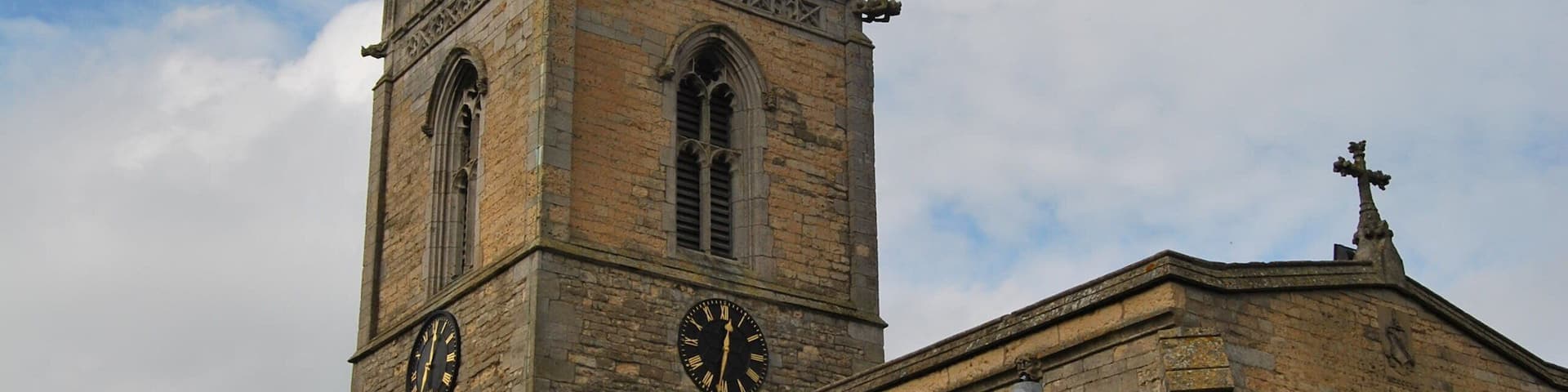 A historic church with a tall spire and clock tower.