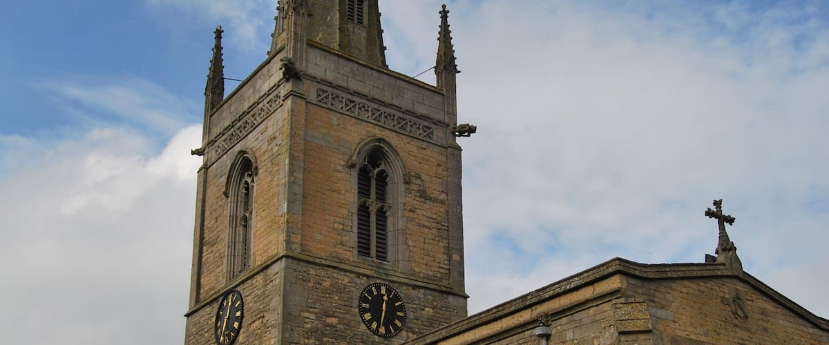 A historic church with a tall spire and clock tower.