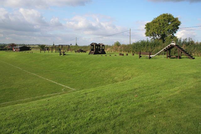 Children's play area Waltham village hall was built on the edge of the playing field. Here is the children's play equipment by the side of the football pitch.