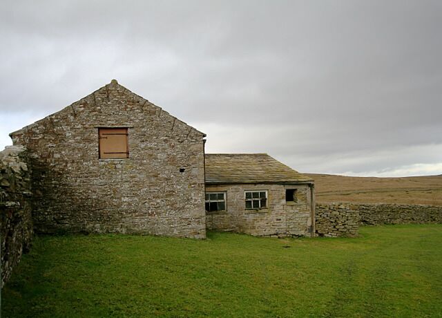Roadside barn at Park Head This barn is built in to the west and south bounding walls of a large field on the north side of the Arkengarthdale road. The roadside, the land south of the road, and that west of the barn are all boggy open fell with much soft rush, but the enclosed land seen in the photograph provides higher quality grazing.