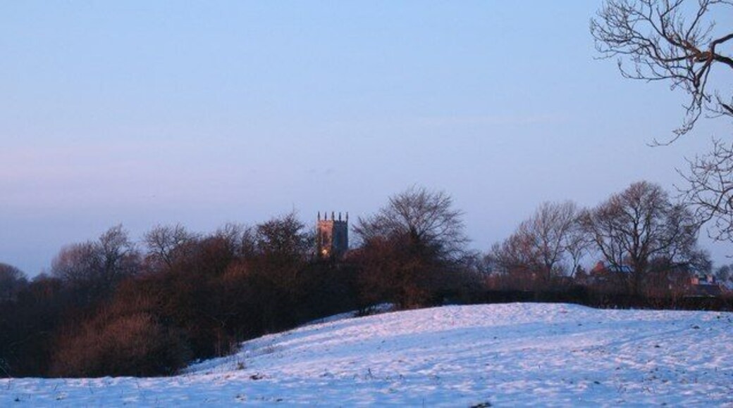 View across snow covered fields to the tower of St Columba's parish church, Topcliffe, North Yorkshire