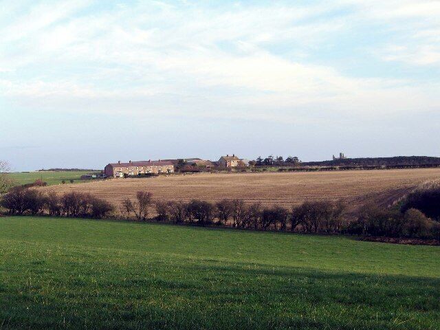 Dunstan Square. The ruins of Dunstanburgh Castle can be seen on the skyline above Dunstan Square farm.