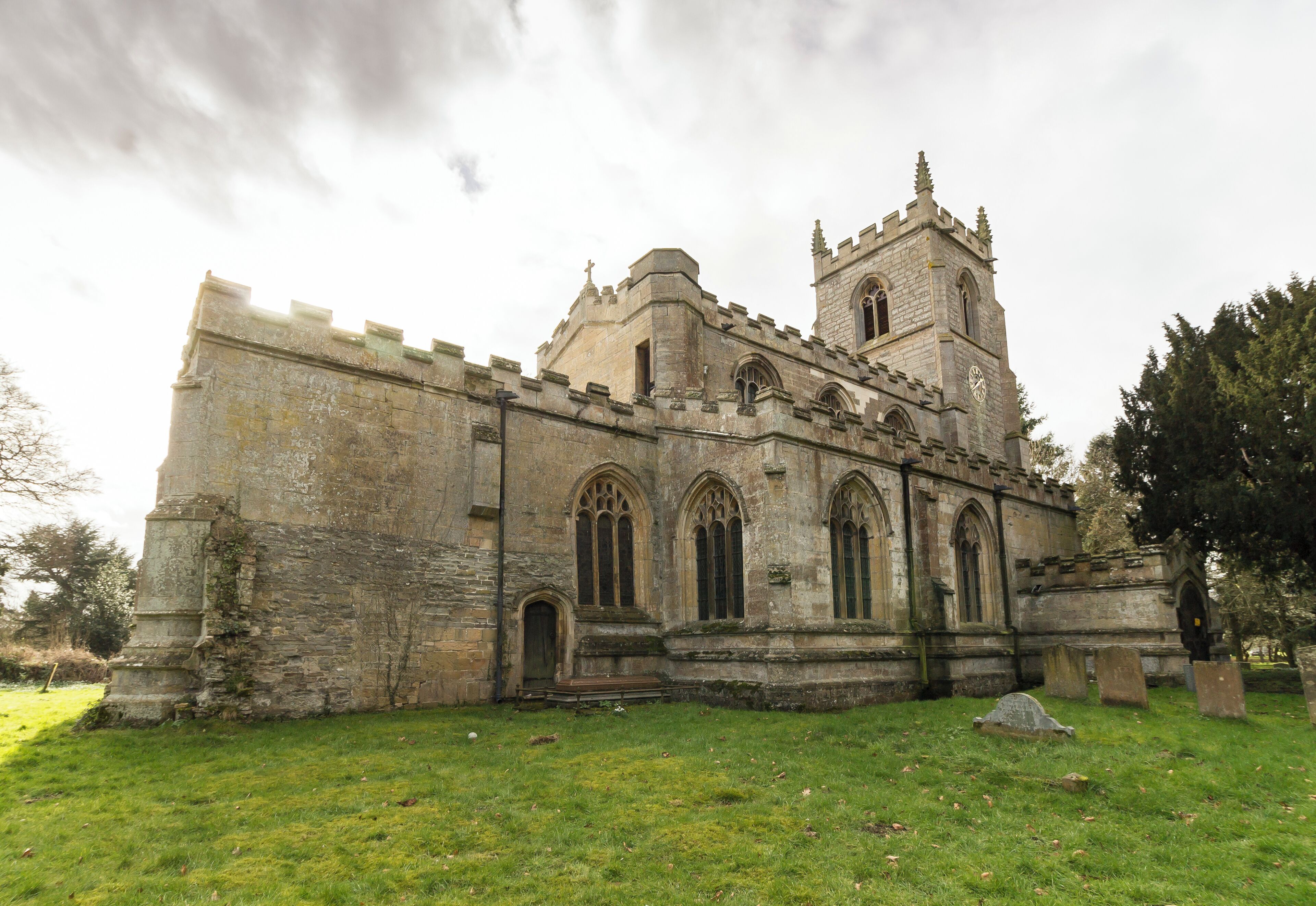 A historic stone church with a prominent tower and arched windows.