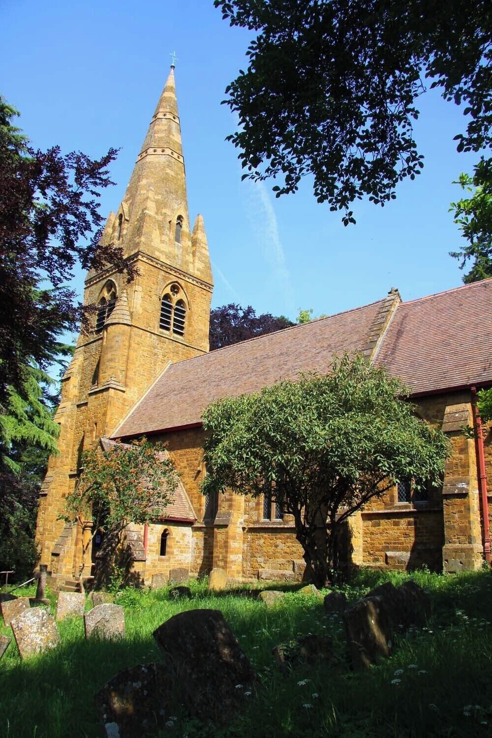 A historic church with a tall bell tower and a brick building.