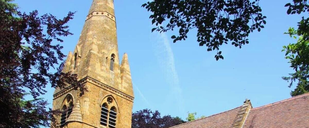 A historic church with a tall bell tower and a brick building.