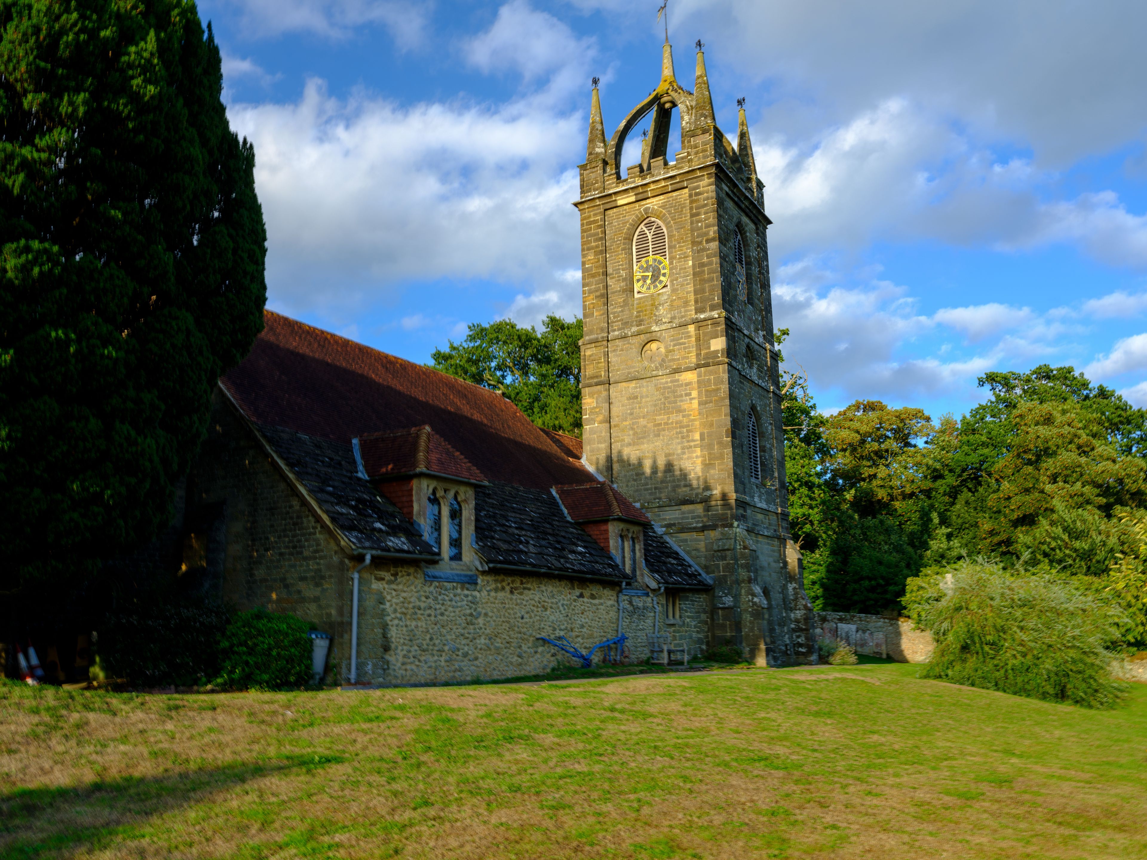 Late afternoon summer light on All Hallow's Church at Tillington next to the Petworth Estate in the South Downs National Park, West Sussex, UK