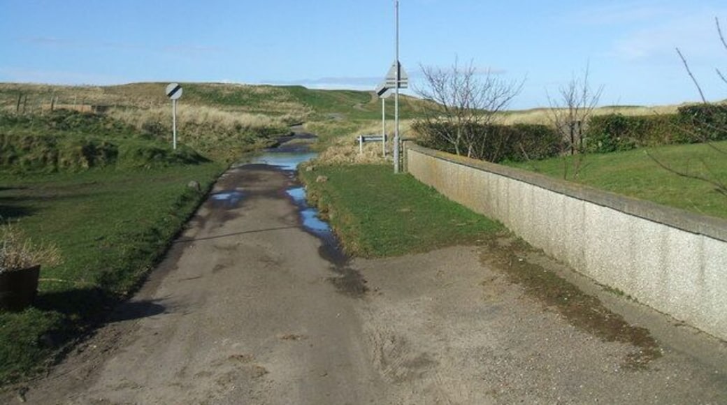 Coastal path out of St Combs It may be observed by the more cynical Geographer that the 'end of speed limit' signs are just a wee bit incongruous.