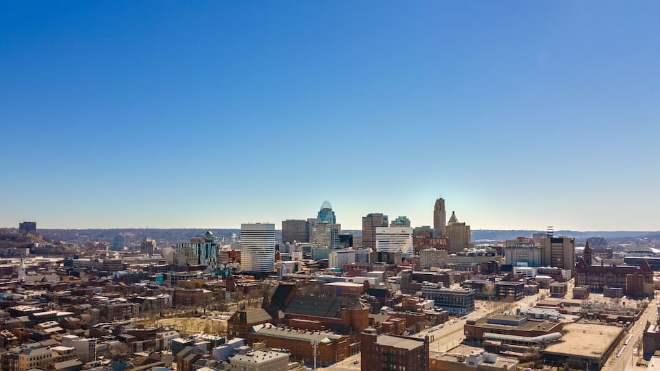 A cityscape with a prominent skyscraper, a river, and a bridge.