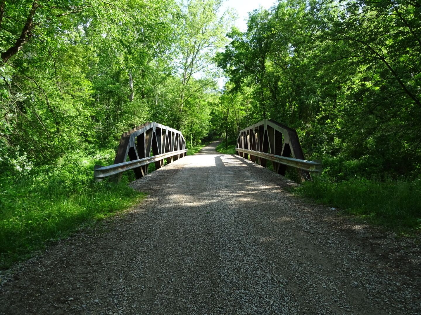This bridge provides vehicle and pedestrian traffic over the 114-mile-long Raccoon Creek as it passes near the Moonville Tunnel.

At one time, a railroad trestle carried the tracks over Raccoon Creek.

There is a small pull off near this bridge that provides parking at a trail head that leads directly to the Moonville Tunnel/

The Moonville Rail-Trail, a sixteen-mile #hiking trail comprising the abandoned railway inside the Zaleski State Forest. 

About all that remains of Moonville is an old railroad tunnel. The town sprang up in the late 1800's because of the Marietta and Cincinnati railroad building through the uninhabited forest on its way to Cincinnati. 

The coal town's population peaked at just over one hundred. The last family left town in 1947. By the 1960s most of the buildings were gone and only the tunnel survives today.