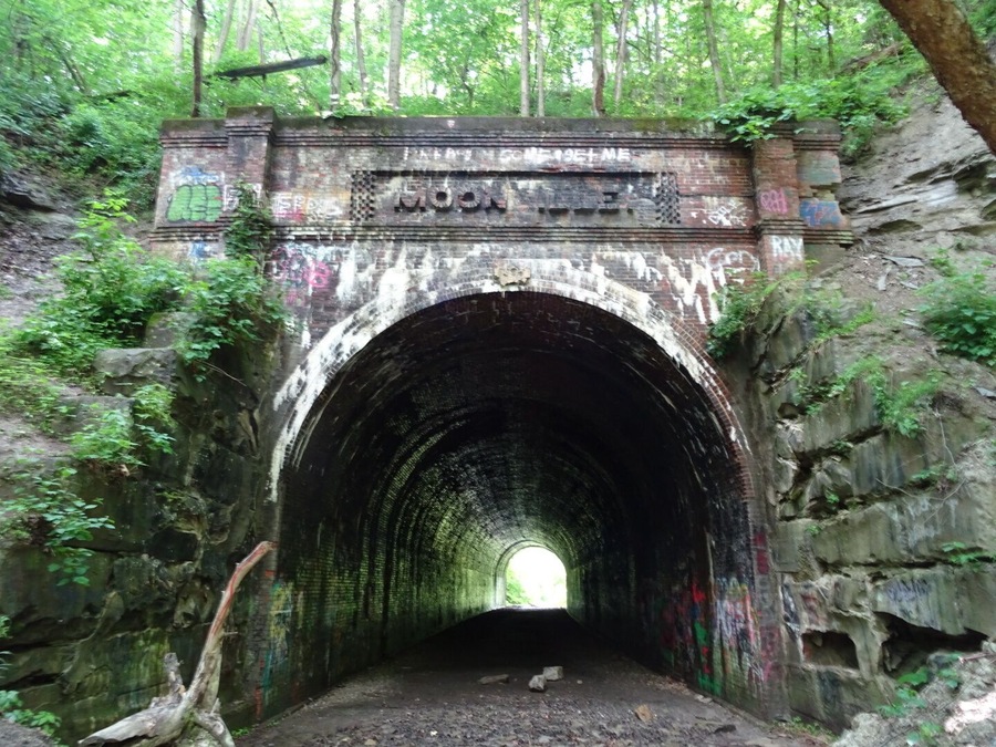 About all that remains of Moonville is this old railroad tunnel. The town sprang up in the late 1800's because of the Marietta and Cincinnati railroad building through the uninhabited forest on its way to Cincinnati.
The coal town's population peaked at just over one hundred. The last family left town in 1947. By the 1960s most of the buildings were gone and only the tunnel survives today.
The Moonville Tunnel can be accessed via The Moonville Rail-Trail, a sixteen-mile #hiking trail comprising the abandoned railway inside the Zaleski State Forest.