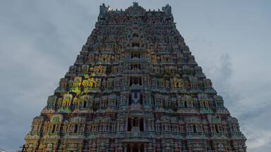 A detailed temple with intricate carvings and a tiered structure.