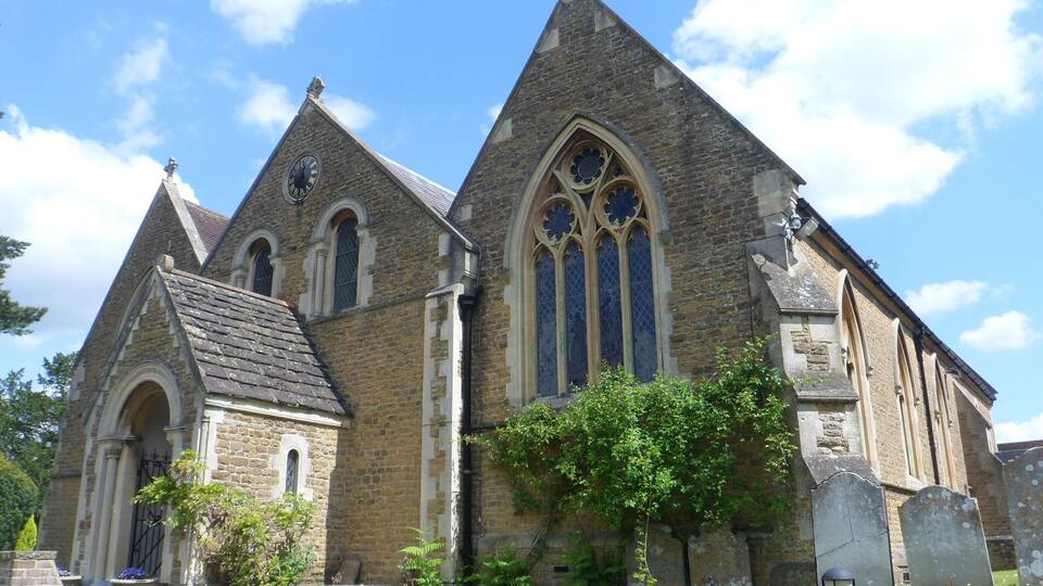 A historic church with pointed towers and large stained glass windows.