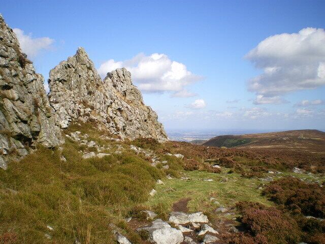 Alongside the rocks of The Devil's Chair This line of pinnacles marks the last of the biggest tors along the Stiperstones ridge, with the Devil's Chair (an amphitheatre about 20 yrds across, looking north) at the north end.