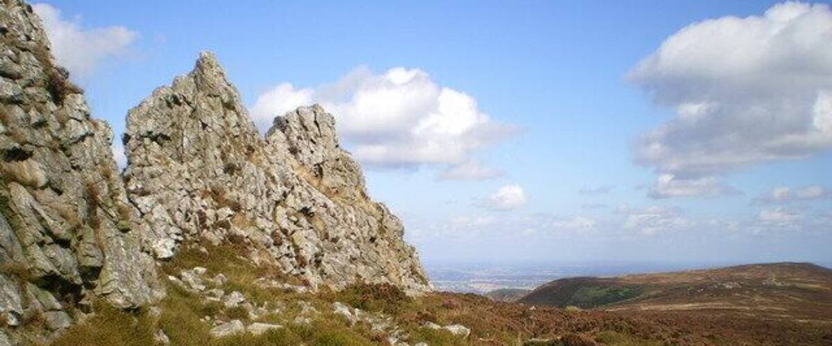 Alongside the rocks of The Devil's Chair This line of pinnacles marks the last of the biggest tors along the Stiperstones ridge, with the Devil's Chair (an amphitheatre about 20 yrds across, looking north) at the north end.