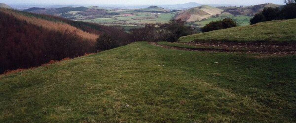 Rolling hills, a valley, and distant fields.