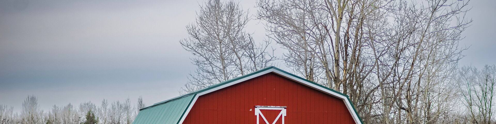 A red barn in a field in Orwell, Ohio