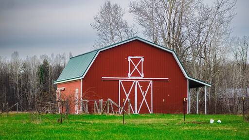 A red barn in a field in Orwell, Ohio