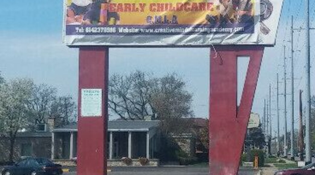 All that remains of the closed local grocery chain Super Duper is the sign with a circus elephant balancing a bag of groceries. The neon tubing remains, but it's unlikely that it still functions. The name of the store resides underneath the day care banner. A quick Google image search for "super duper supermarket" will provide some insight to the sign before its current cloaking.
