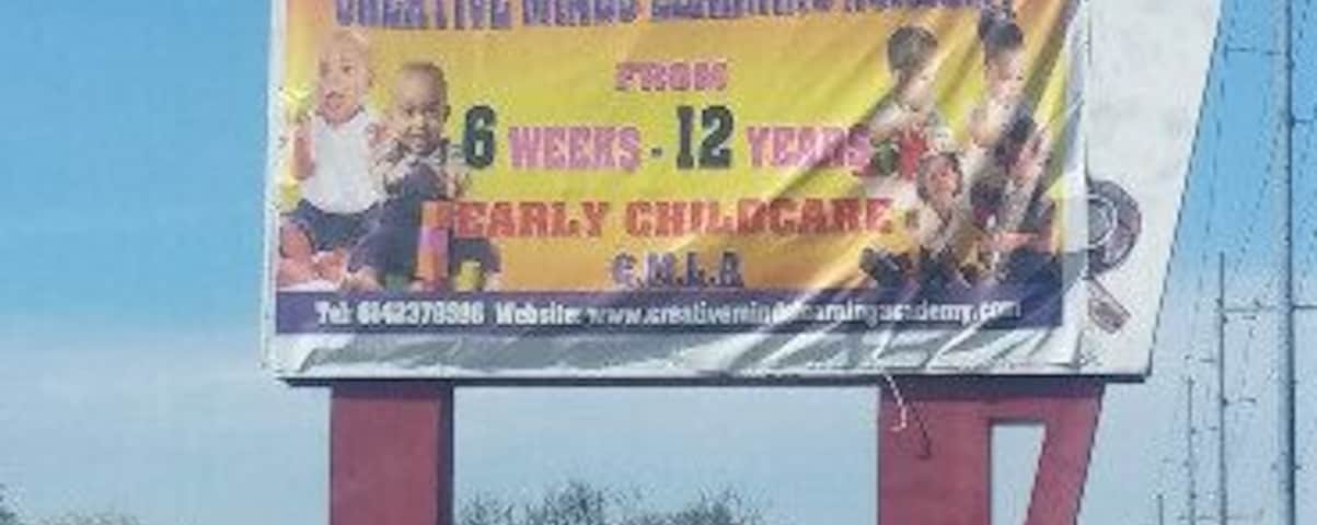 All that remains of the closed local grocery chain Super Duper is the sign with a circus elephant balancing a bag of groceries. The neon tubing remains, but it's unlikely that it still functions. The name of the store resides underneath the day care banner. A quick Google image search for "super duper supermarket" will provide some insight to the sign before its current cloaking.