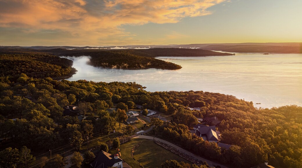 Sunset sky over the Tenkiller lake, Oklah and green forested area in the evening