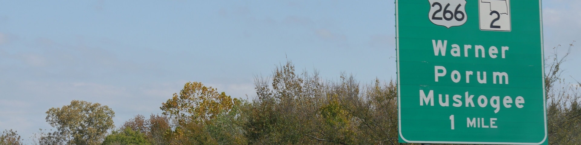 Road sign and direction to the exit for Warner, Porum and Muskogee, Oklahoma.