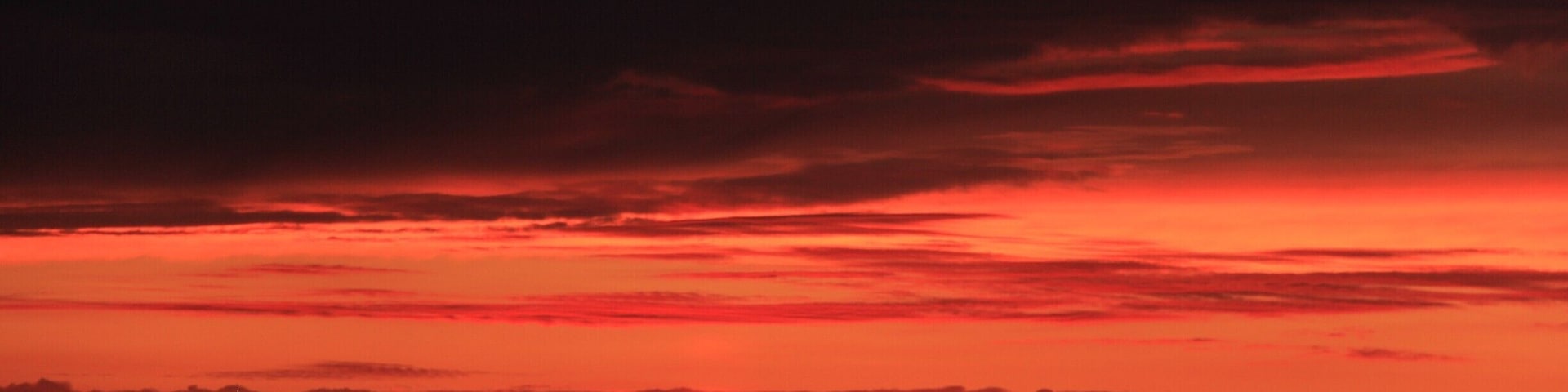 Sunset on the way to Fort Klamath from Crater lake. Had no choice but to pull over the car and see the sun sink down. Red , orange violet color sky with wast empty lands , hay , birds flying and horse stables. Very very beautiful views.