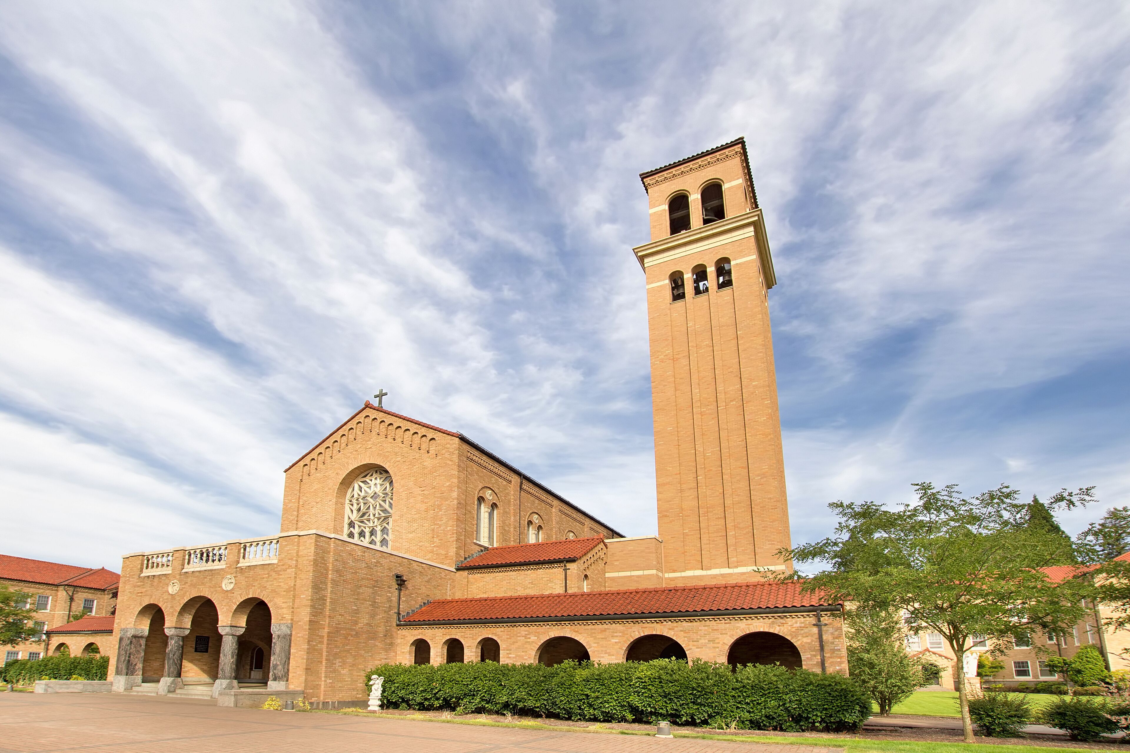 A large brick church with a tall tower and arched windows.
