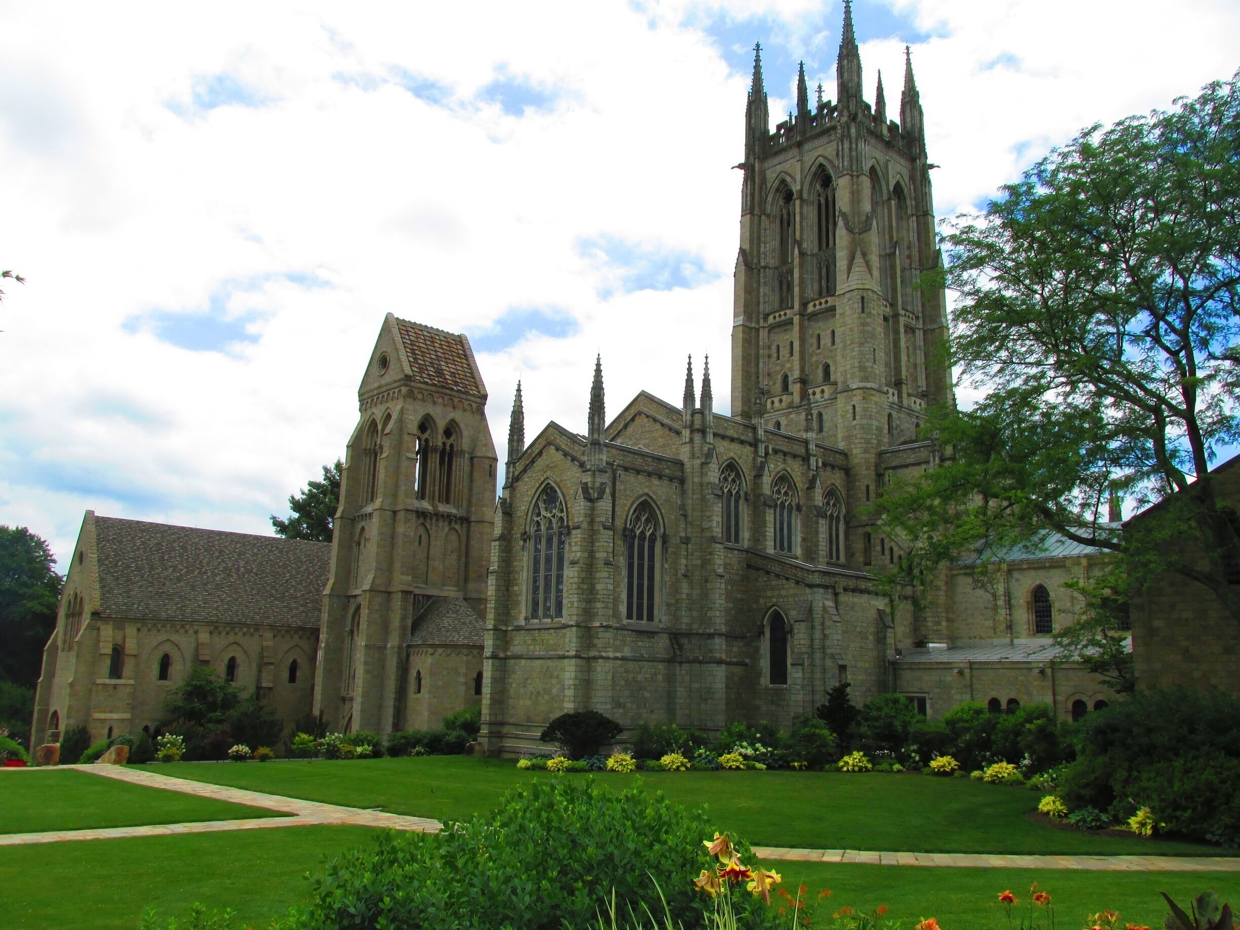 A historic cathedral with a tall tower and a smaller adjacent building.