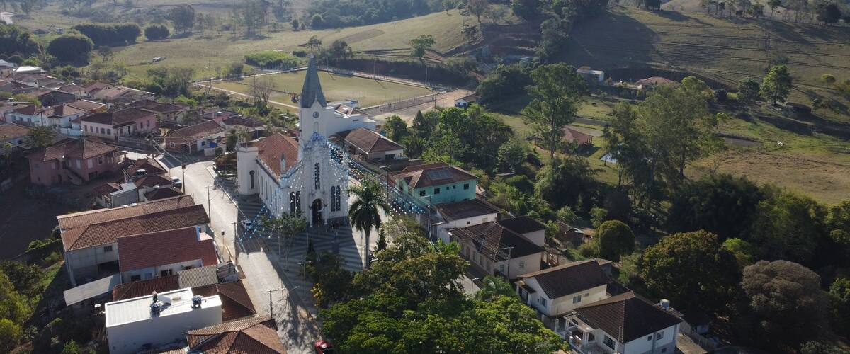 A town with a prominent church, surrounded by rolling hills and green fields.