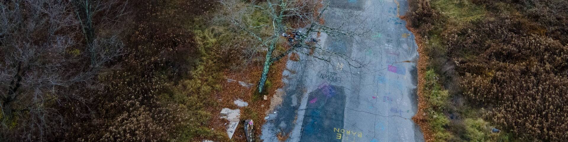 Aerial landscape of graffiti road and forest during Fall around abandoned coal town Centralia Pennsylvania