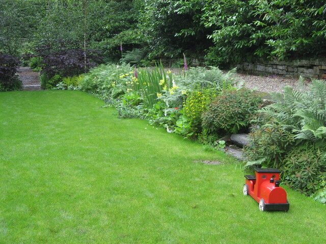 The train now standing at Platform 2 ... ... left about 50 years ago. The lawned area is the old track bed at Langley Garden Station and the gravelled area on the right is the old platform opposite the wooden station buildings which can be seen in one of the other images for this grid square.