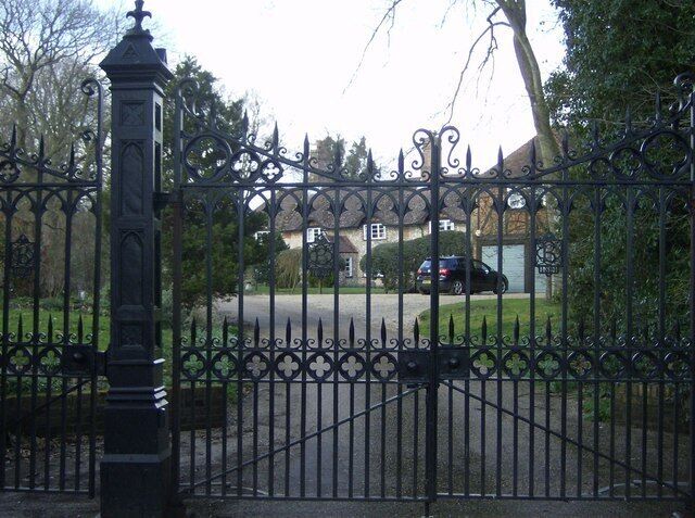Gates of Bighton House From the minor road, this set of gates is the imposing entrance to the long drive of Bighton House. Pedestrian access to the footpath is through the gate to the left. The house itself is still half a mile away.