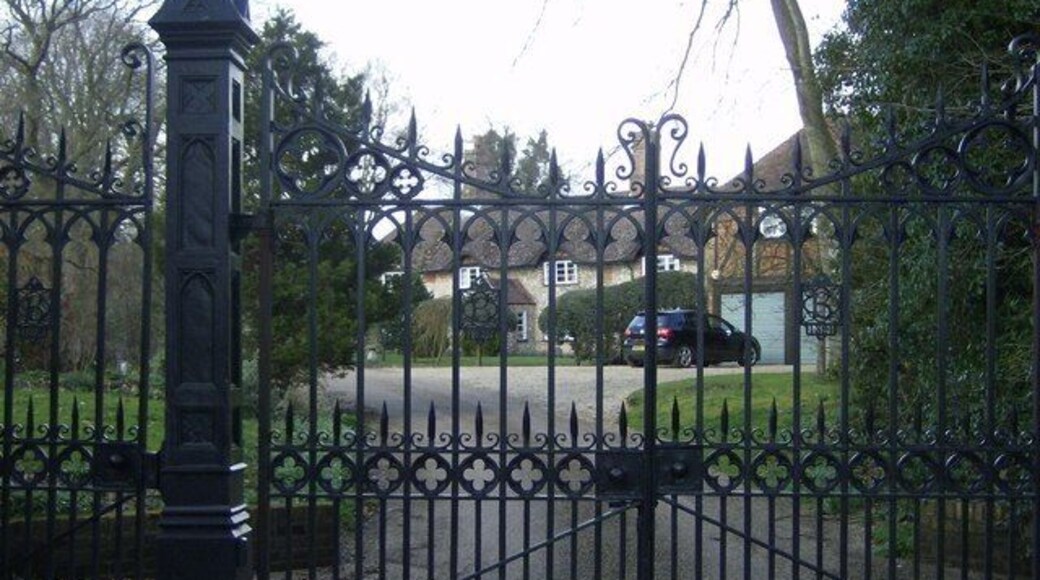 Gates of Bighton House From the minor road, this set of gates is the imposing entrance to the long drive of Bighton House. Pedestrian access to the footpath is through the gate to the left. The house itself is still half a mile away.