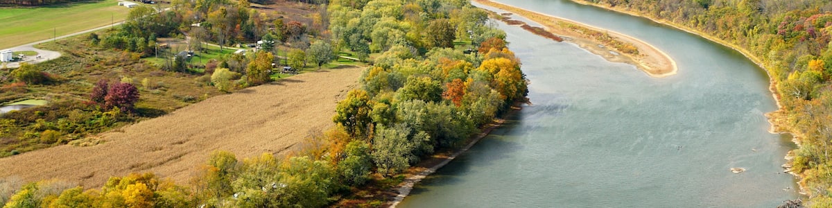 The aerial view of the Susquehanna River surrounded by striking color of fall foliage near Wyalusing, Pennsylvania, U.S