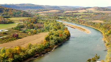 The aerial view of the Susquehanna River surrounded by striking color of fall foliage near Wyalusing, Pennsylvania, U.S