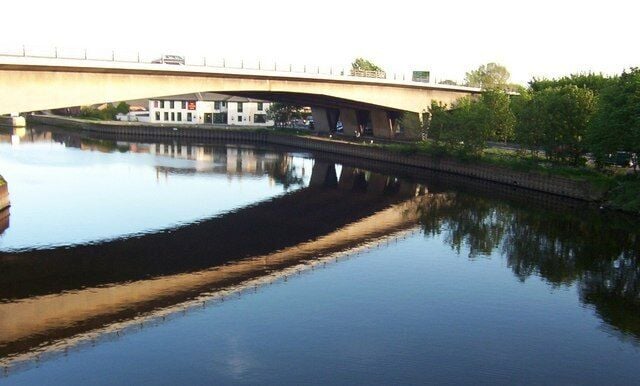 Ferrybridge This shot was taken from the original (John Carrs) bridge at Ferrybridge. The river is the River Aire and the large structure is the A1 Motorway bridge. The white building seen below the A1 is the Golden Lion public house.
