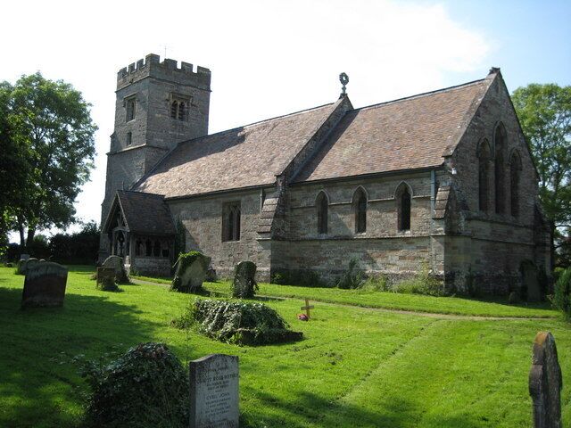 A historic church with a tower and a graveyard.